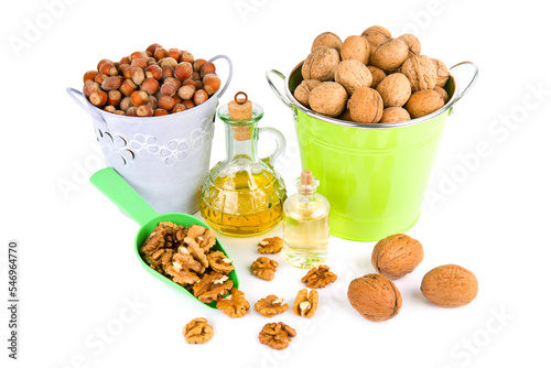 Walnuts, hazelnuts and natural walnut oil isolated on white .