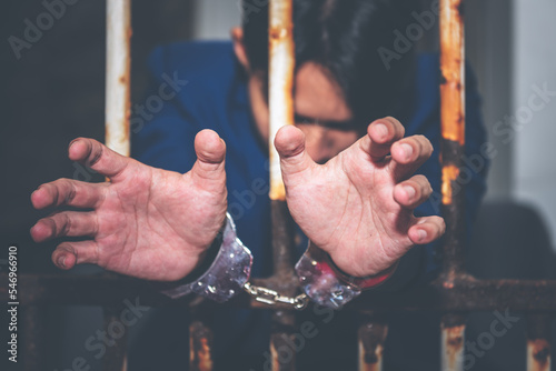 Quadro su tela Asian male criminals were arrested and handcuffed in a dirty cage, concept to th