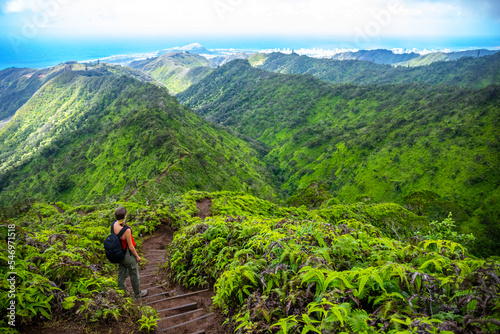 hiker girl enjoys the panorama of oahu island and honolulu in hawaii islands while climbing wiliwilinui ridge trail  hiking on green mountains in hawaii, holidays in hawaii © Jakub