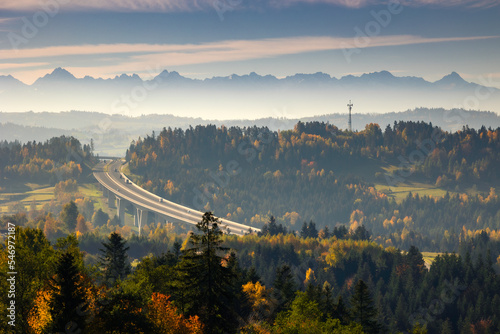 Highway towards the Tatra Mountains in autumn scenery with a view of the highest peaks in Poland.