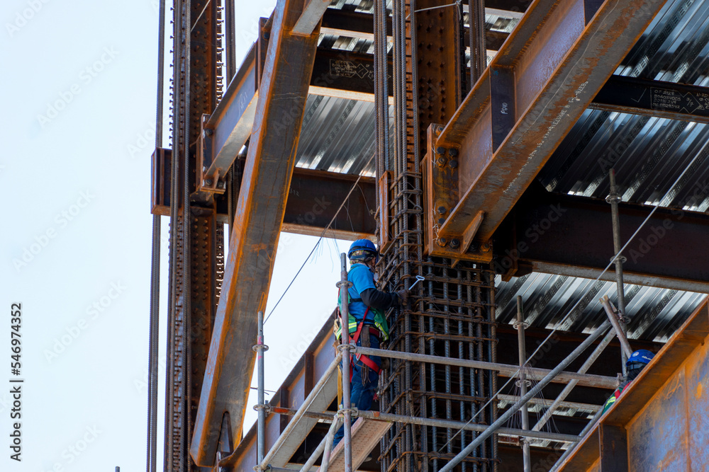 man welding steel on a girder at heights, building structure, mexico guadalajara man welding steel on a girder at heights, building structure, mexico guadalajara