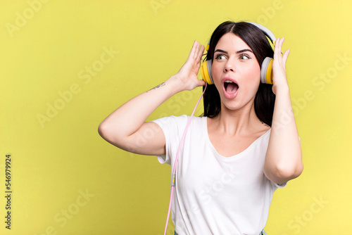 feeling happy, excited and surprised. listening music qith a headphones photo