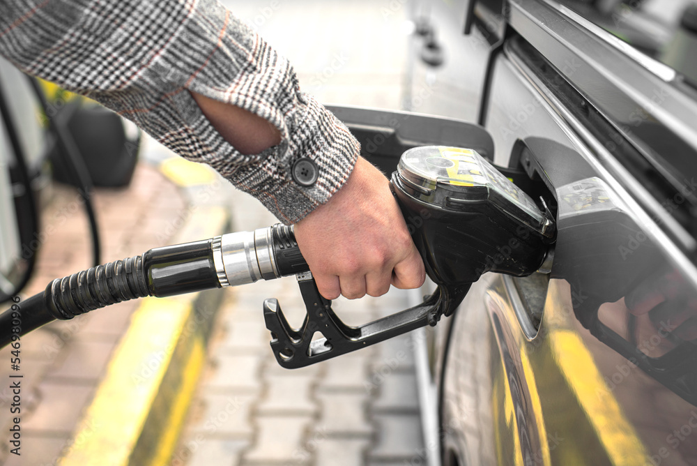 A man is filling up his car. Refueling the car. Rising gasoline prices. A man is filling up his car. Refueling the car. Rising gasoline prices.