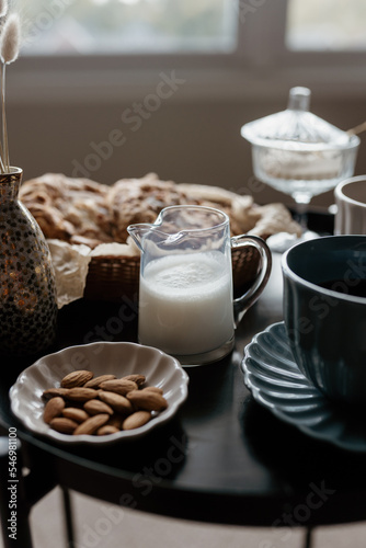 Aesthetic breakfast. Milk coffee  milk tea  sugar  almond  almond cakes  biscuits  marzipans and puffs. British breakfast in a cozy home. Autumn mood.