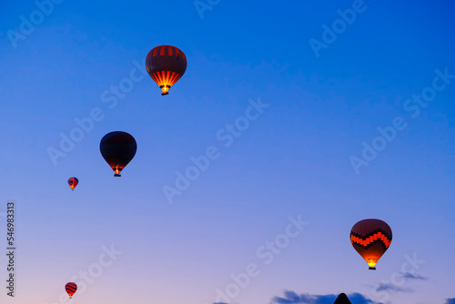 Colorful hot air balloons flying over fairy chimneys, Cappadocia, Turkey. © Goldenshot