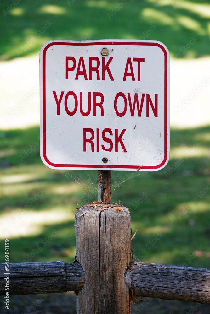 PARK AT YOUR OWN RISK sign
