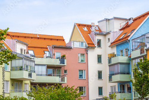 Colorful apartment complex around a small park. © Trygve