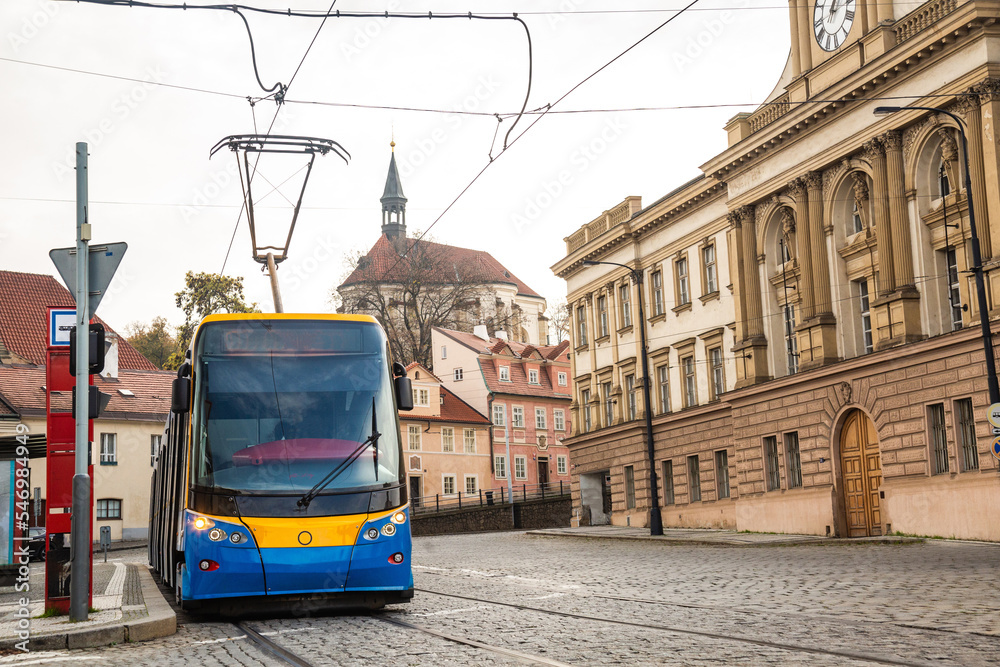 Modern Tram in old stree of Prague in a summer day, Czech Republic. The Prague tram network is the third largest in the world. Passenger Eco-friendly electric transport connection in the Europe City