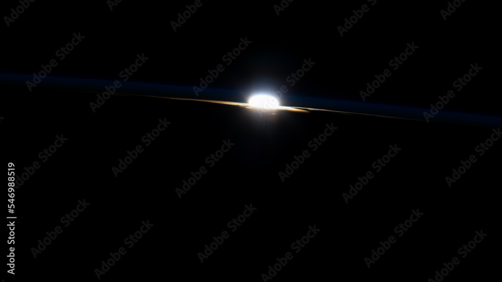 Rays of an orbital sunset through Earth's horizon. Sunset over planet on outer space. Elements of this image furnished by NASA. 