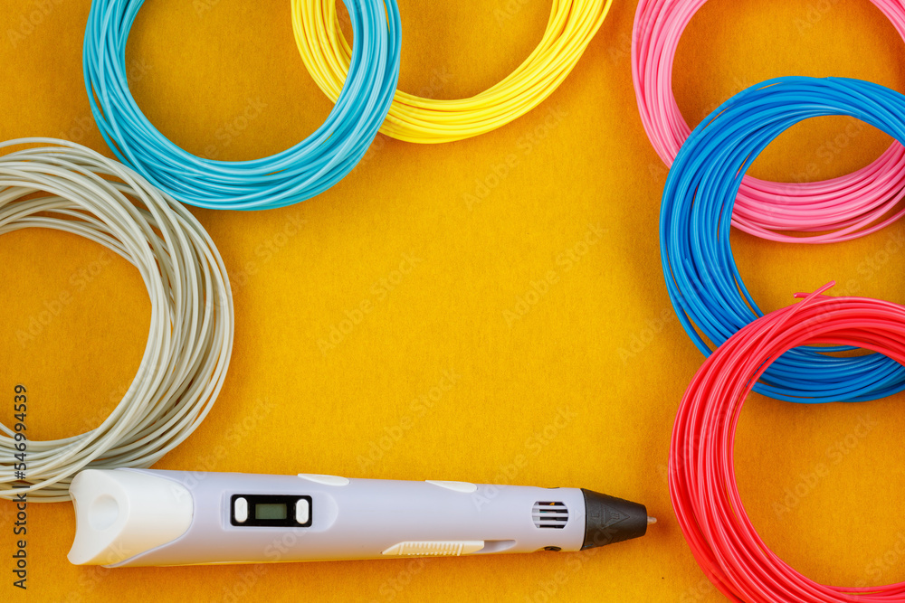 3d pen, and kit of colourful PLA or ABS plastic filament on yellow background. Close-up - obrazy, fototapety, plakaty 