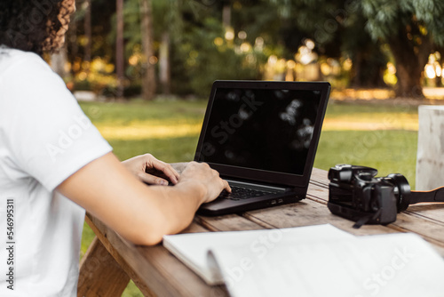 A Person With A Laptop In a Park.