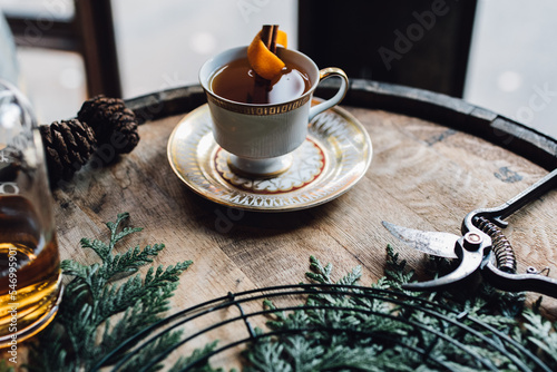 whiskey hot toddy on bourbon barrel with holiday wreath making materials clippers photo