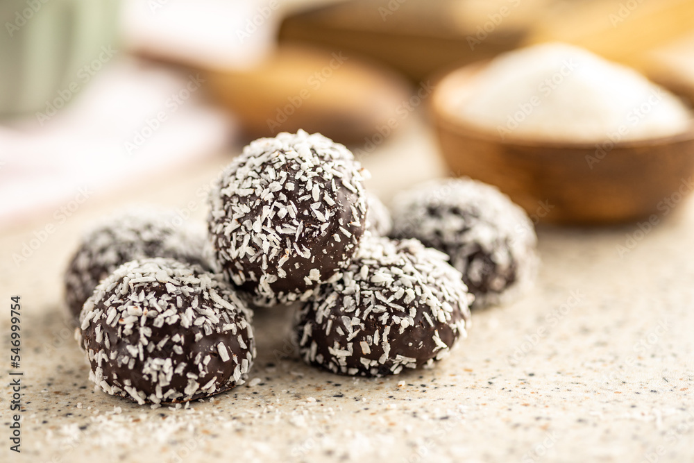 Coconut chocolate balls on kitchen table. Coconut chocolate balls on kitchen table.