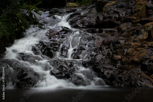 beautiful waterfall in a small river in the middle of the forest