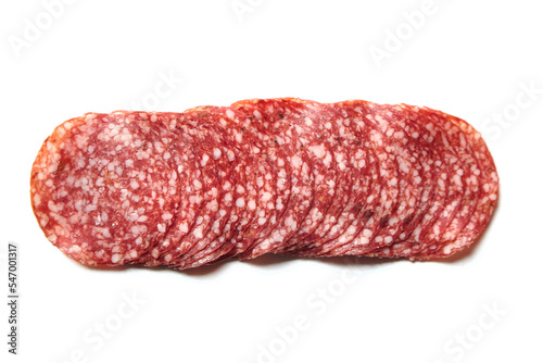 Thin sliced salami sausage isolated on white. Thin sliced italian dry salame, top view