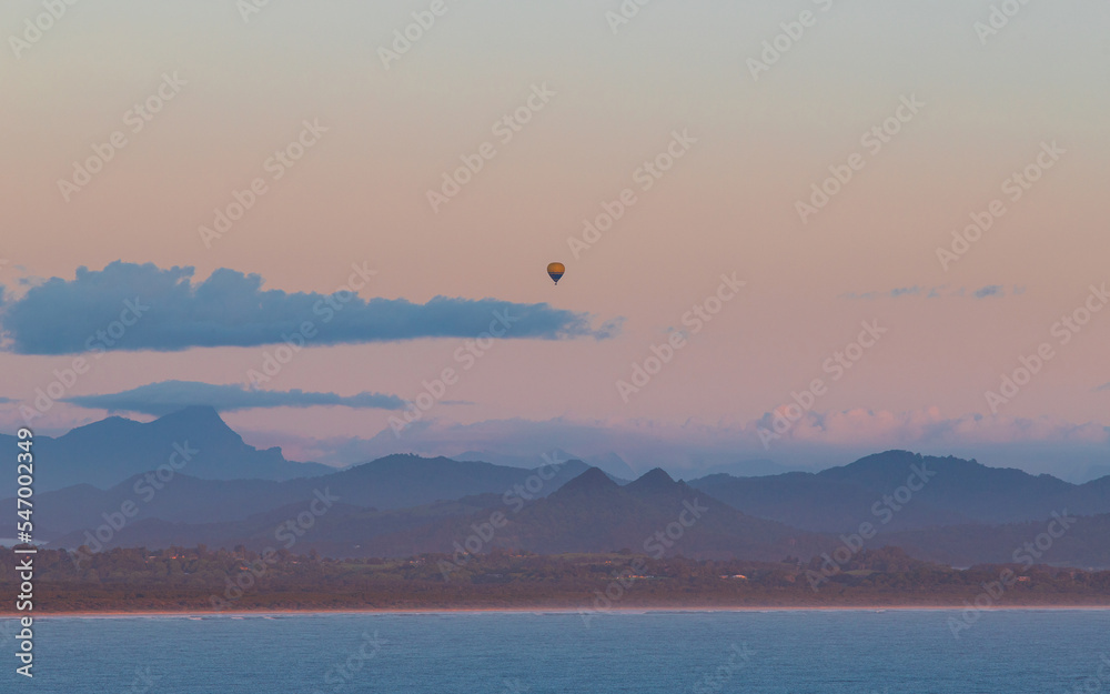 Hot air balloon above the mountains and the ocean. Hot air balloon above the mountains and the ocean.