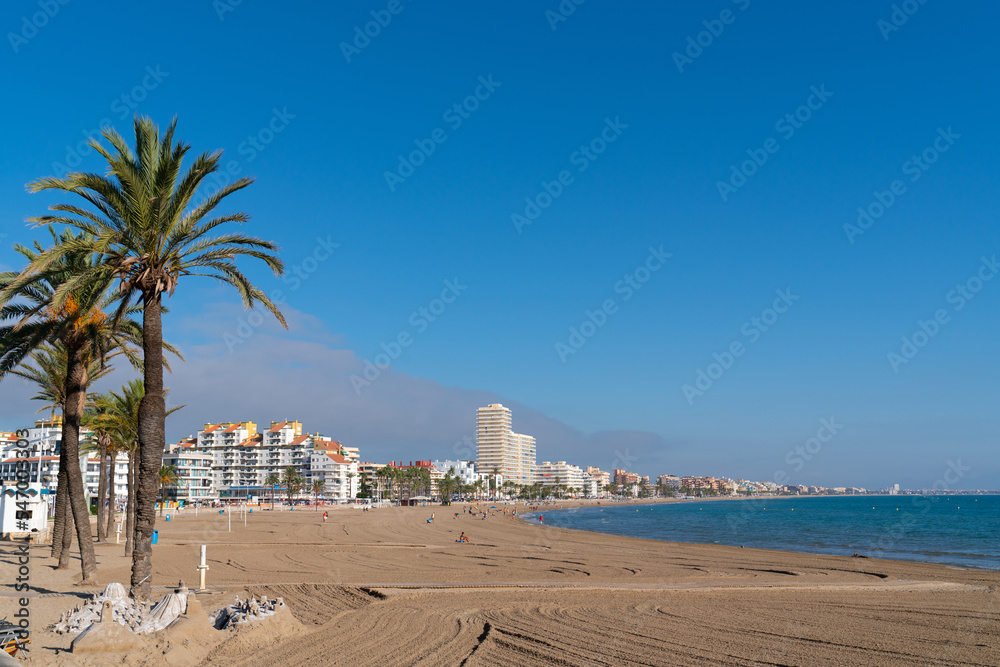 Peniscola Spain beach with palm trees one of the best beaches on the Costa del Azahar