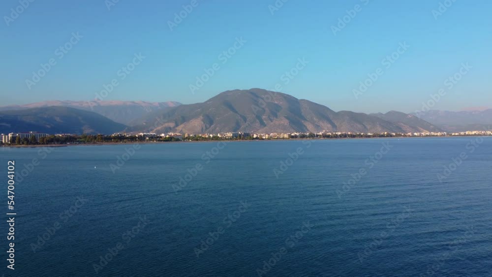 sunset over the sea with a view of the mountains and yachts, pier, lighthouse sunset over the sea with a view of the mountains and yachts, pier, lighthouse