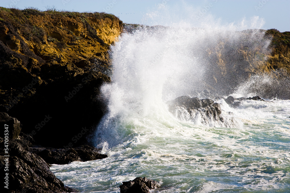 Ocean waves break against rocky outcrops along the Central Coast of California.