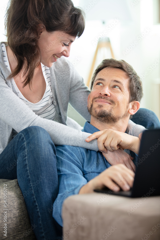 cheerful beautiful young couple on the sofa