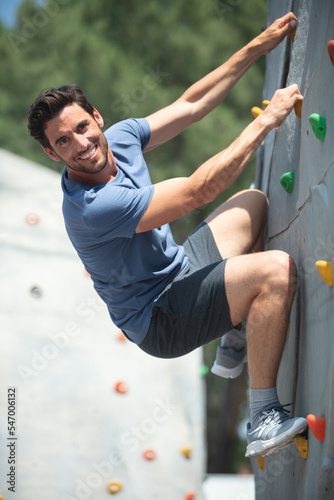middle aged man on an artificial climbing wall