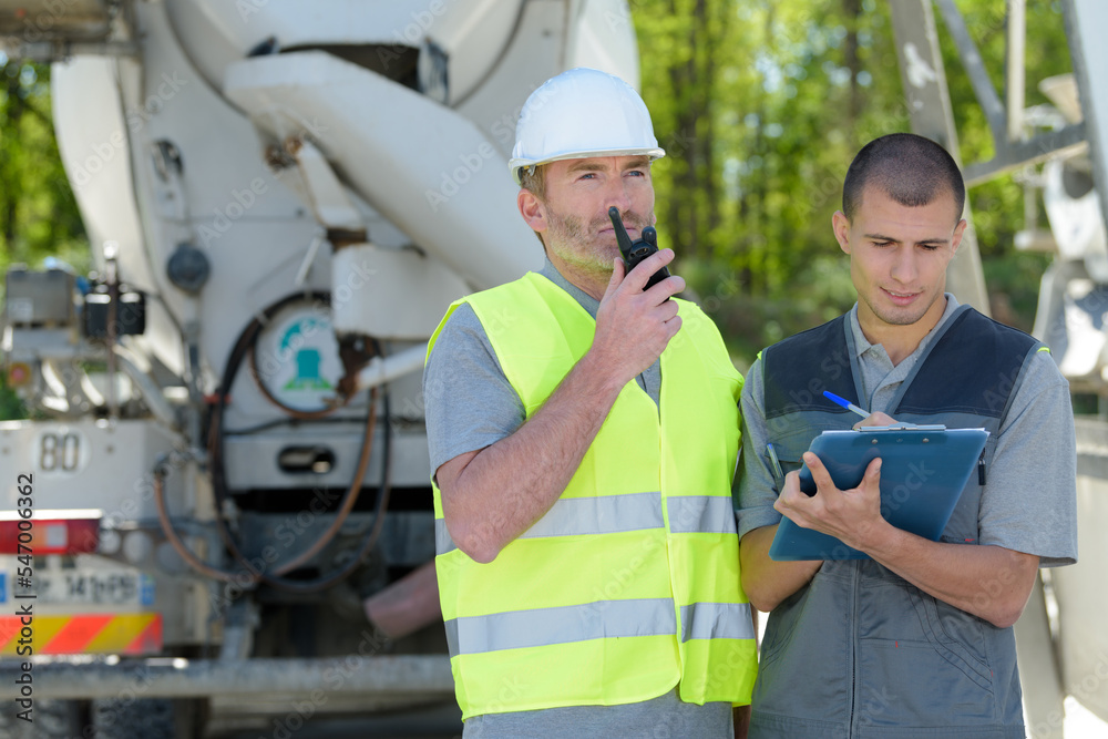 construction worker reporting cement delivery construction worker reporting cement delivery