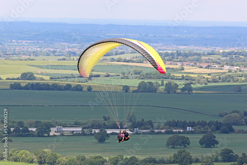 Tandem Paraglider flying from Combe Gibbet, England 