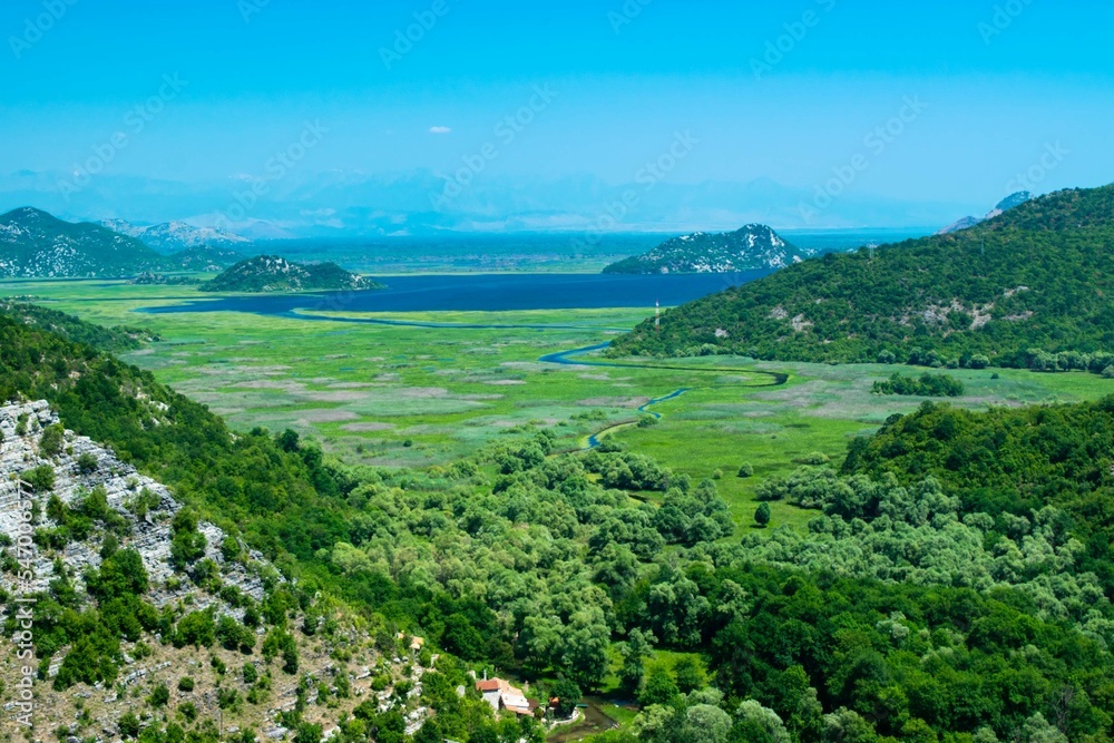 Top view of beautiful summer landscape of Skadar Lake with green and blue water, mountains hills. Montenegro.