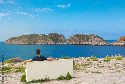 Islas Malgrats (Mallorca). Hombre contemplando el mar, sentado en un banco de piedra frente a las islas Malgrats, en Santa Pona (Mallorca9 photo