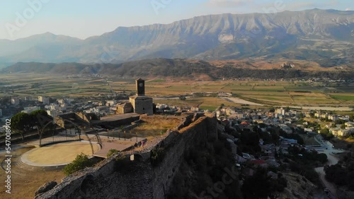 Castle of Gjirokastra and old city center. Aerial view of ancient fortress, houses and mountains in Gjirokaster, Albania