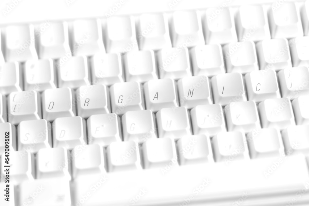 A white keyboard with the letters rearranged to spell the word organic A white keyboard with the letters rearranged to spell the word organic