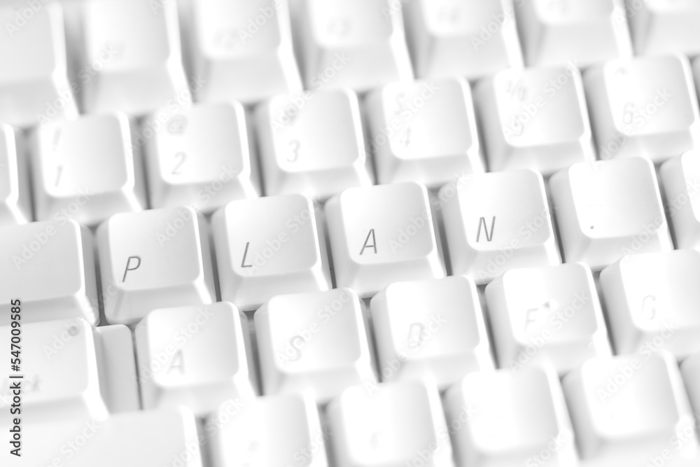 A white keyboard with the letters rearranged to spell the word Plan A white keyboard with the letters rearranged to spell the word Plan
