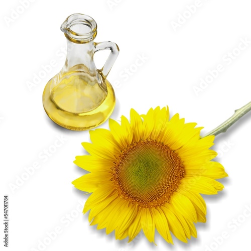 Sunflower oil in glass bottle and fresh flower