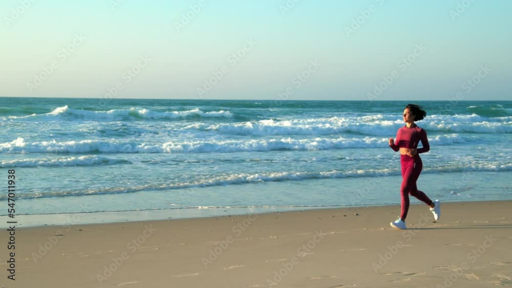 Young woman jogging and training on the beach in morning Young woman jogging and training on the beach in morning