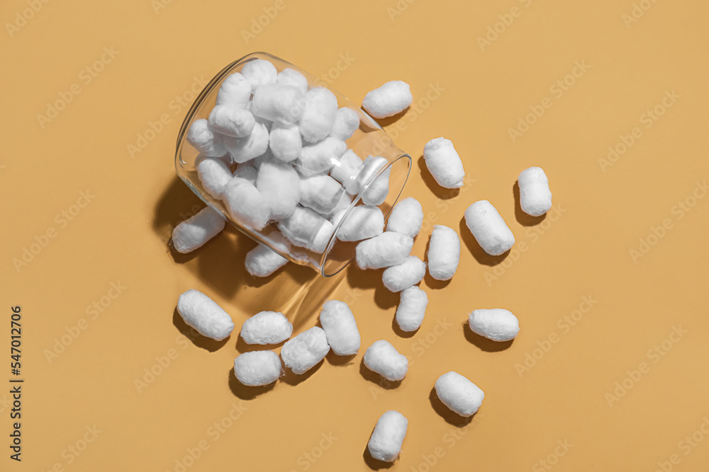 Jar of soft cotton balls on color background Jar of soft cotton balls on color background