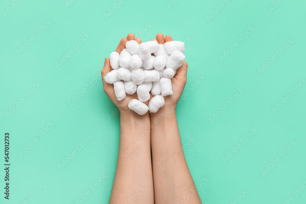 Woman with soft cotton balls on color background Woman with soft cotton balls on color background
