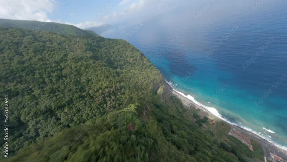 FPV drone flying over the mountains in rocky coast of Madeira, Portugal