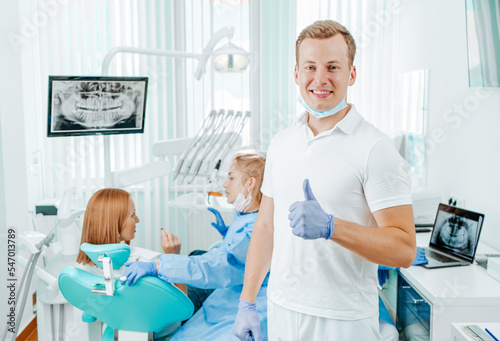 Doctor dentist in dental clinic on backdrop with medical equipment, x-ray dental and patient. Smile healthy teeth concept