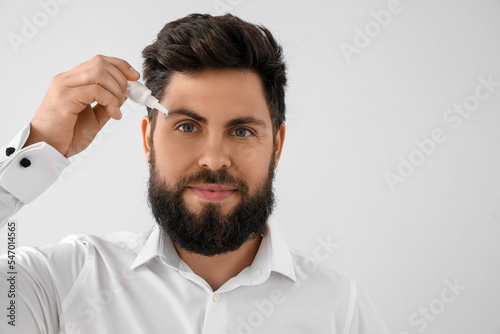 Handsome man with eye drops...