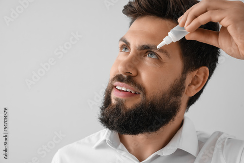 Handsome man with eye drops...