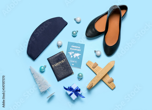 Stewardess accessories with Christmas decor and gift on blue background
