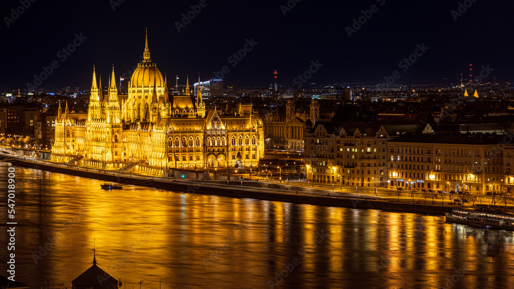 Illuminated Hungarian Parliament Building and Danube river. Budapest, Hungary.