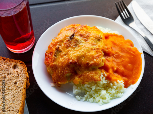 Traditional Ukrainian delicious chicken fillet with mushrooms and rice. Slavic cuisine