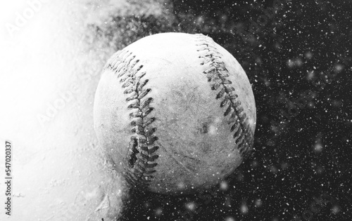 Baseball in snow shows ball in black and white, winter game concept.