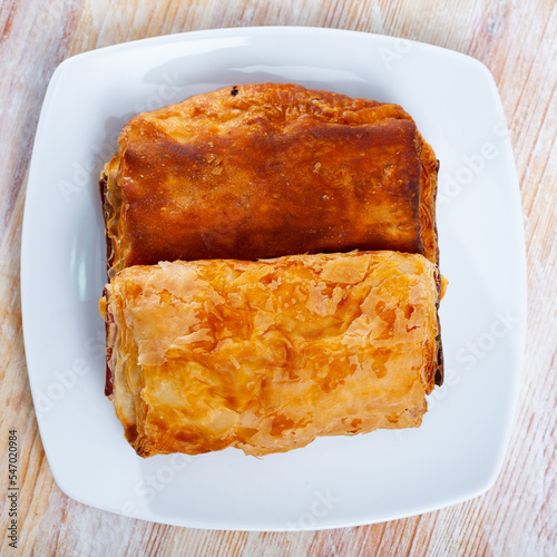 Crisp napolitana from puff pastry filled with minced meat and cheese. Traditional Spanish pastries photo