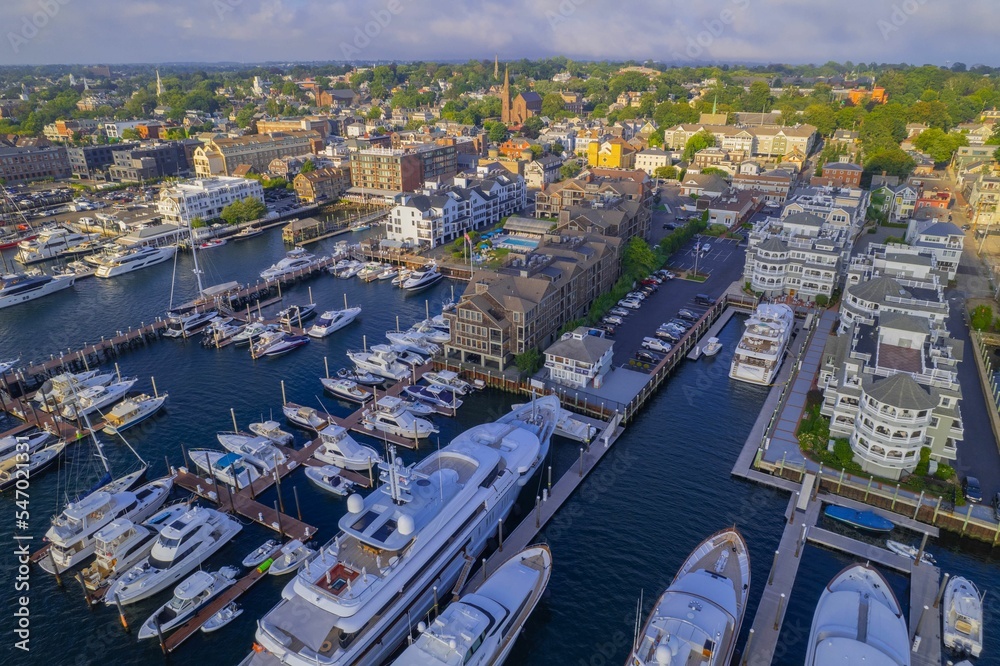Obraz premium Aerial shot of the Newport Harbor in Rhode Island with ducked boats and a landscape