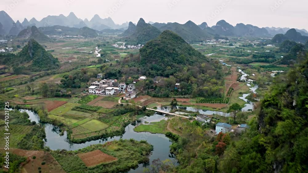 Aerial shot of the amazing rock formations rural towns near the Li River in Yangshuo County China. Hazy day. Aerial shot of the amazing rock formations rural towns near the Li River in Yangshuo County China. Hazy day.