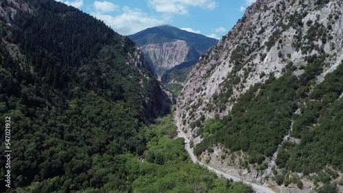 Areal drone footage from Karpenisi area, into the mountains and lake.