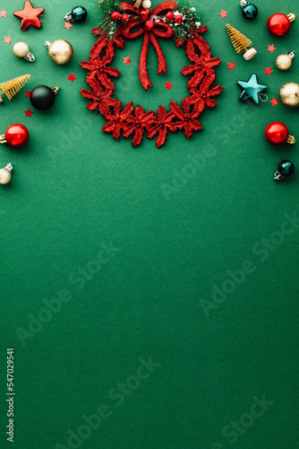 Flat lay vintage Christmas ornaments on green background. Christmas vertical background.