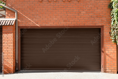 Brown modern roller garage doors on building